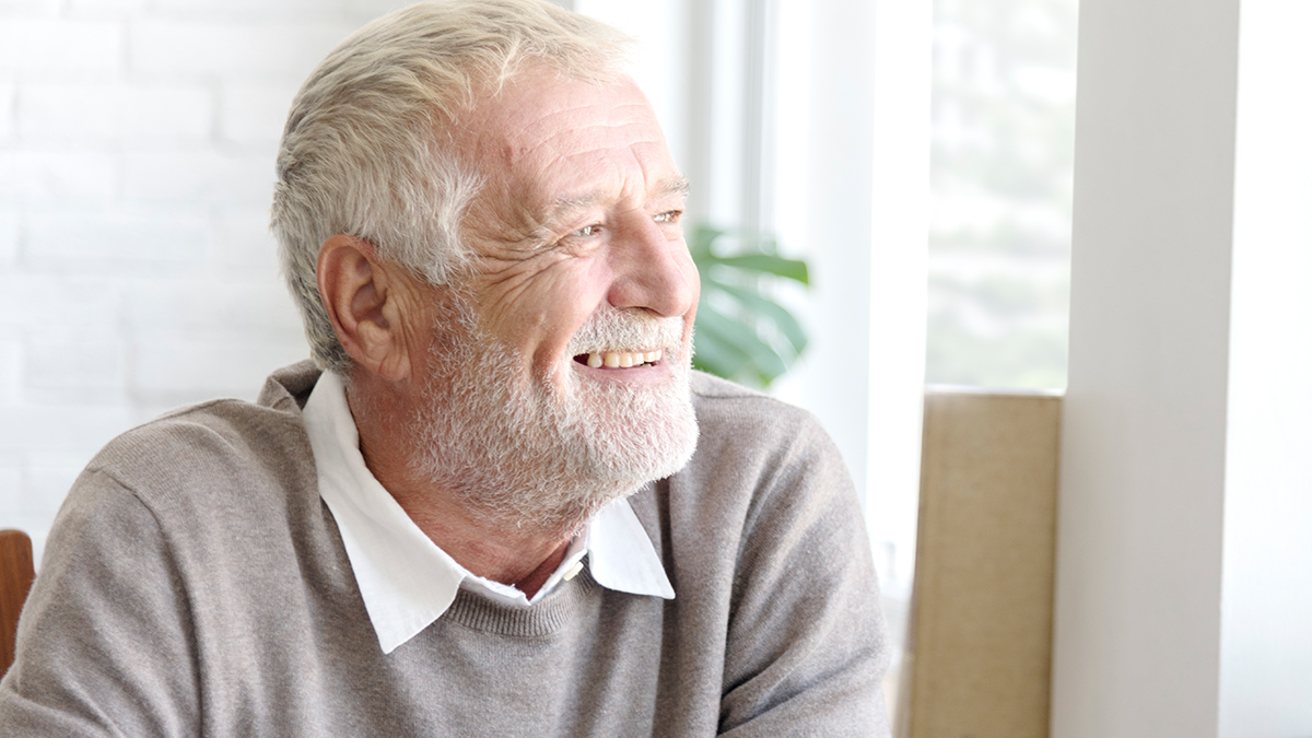 Senior man thinking, looking at the window thinking of the best Medicare Advantage plan